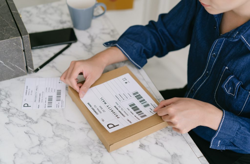 asian-male-entrepreneurs-packing-product-shipping-order-box-labeling-delivery-package-with-barcode-1024x673